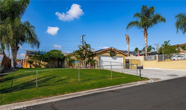 view of front of house with a front yard and a garage