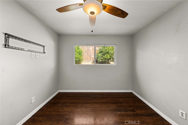 empty room with ceiling fan and dark wood-type flooring