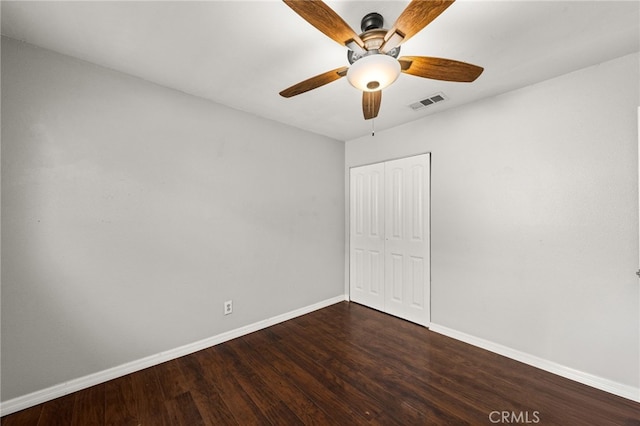 spare room with dark wood-type flooring