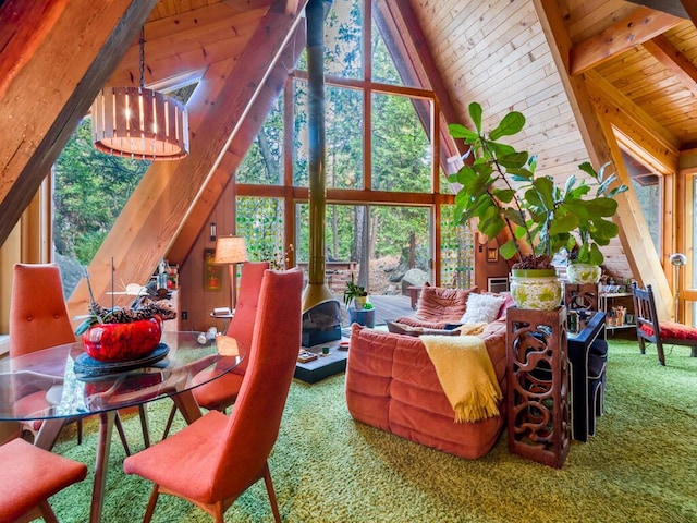 living room with wooden ceiling, carpet, beamed ceiling, a notable chandelier, and high vaulted ceiling