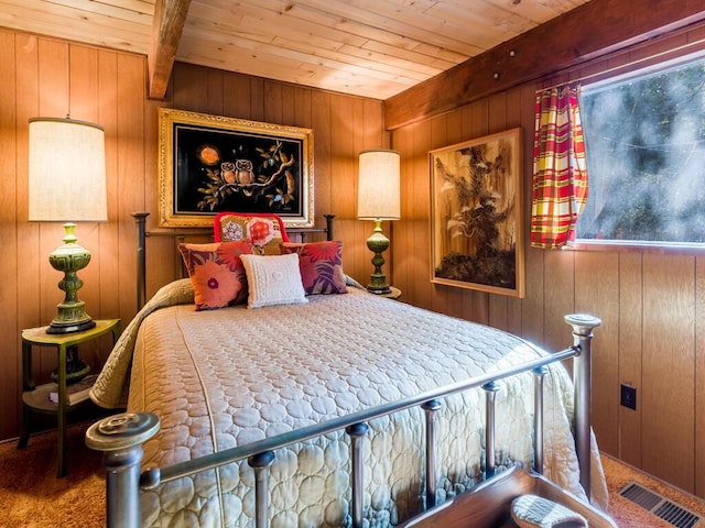 carpeted bedroom with beam ceiling, wooden ceiling, and wood walls