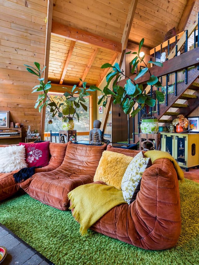 living room featuring wooden walls, vaulted ceiling with beams, and wood ceiling