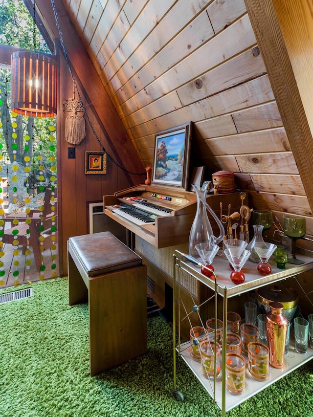 interior space featuring wood ceiling, vaulted ceiling, wooden walls, and carpet