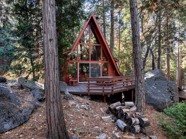 back of property featuring a wooden deck