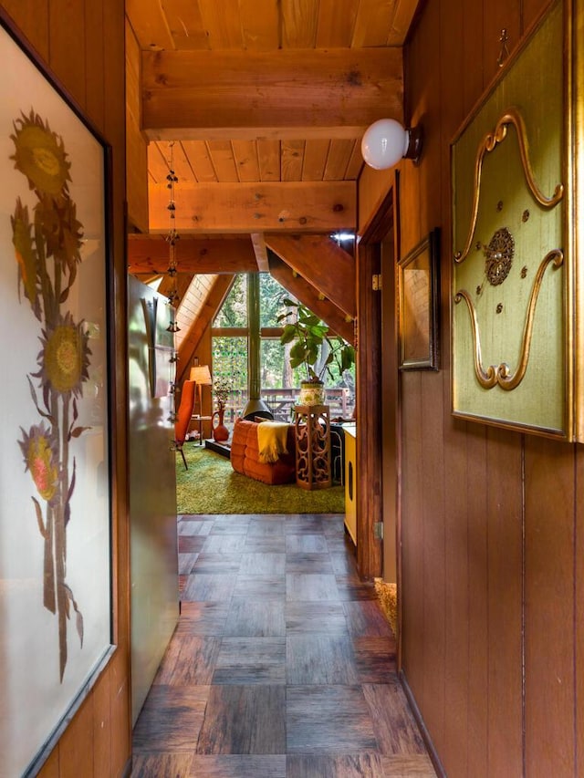 hall featuring wooden ceiling, beamed ceiling, and wood walls