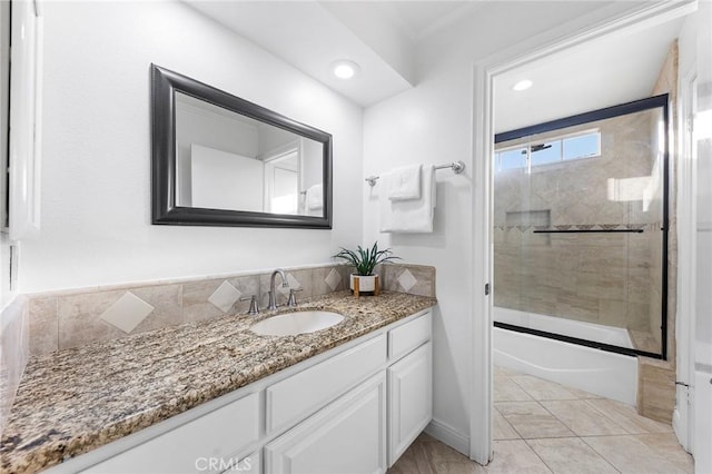 bathroom featuring tile patterned floors, vanity, and bath / shower combo with glass door