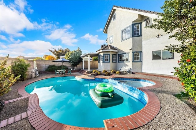 view of swimming pool with a patio area and an in ground hot tub