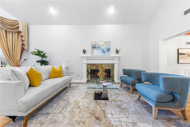 living room featuring wood-type flooring and a fireplace