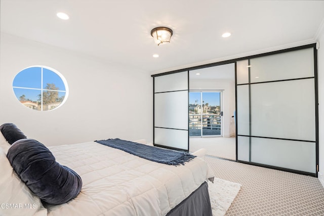 carpeted bedroom featuring expansive windows