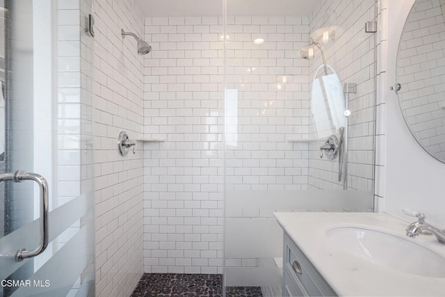 bathroom featuring vanity and an enclosed shower