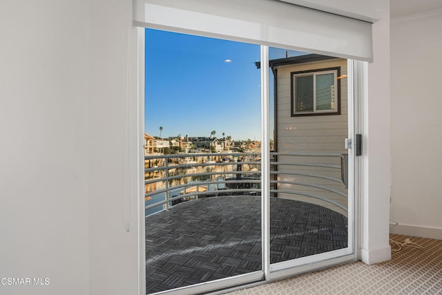 doorway to outside featuring crown molding