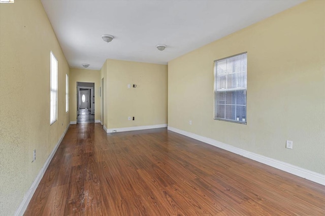 empty room with dark wood-type flooring