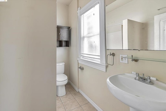 bathroom featuring tile patterned flooring, toilet, and sink