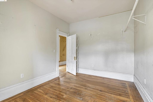 empty room with wood-type flooring