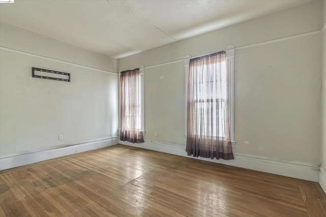 empty room with wood-type flooring