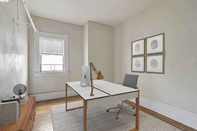 office featuring light hardwood / wood-style floors and a baseboard heating unit