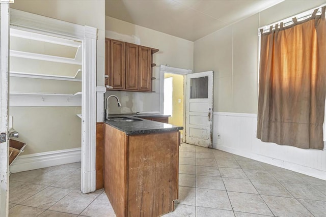 kitchen with light tile patterned floors and sink