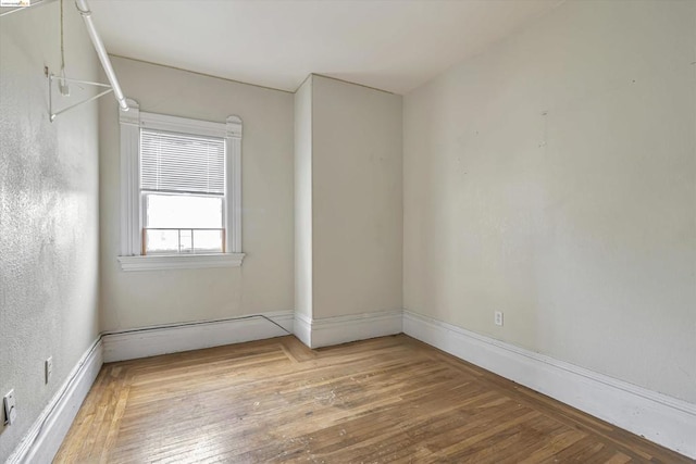 spare room with hardwood / wood-style floors