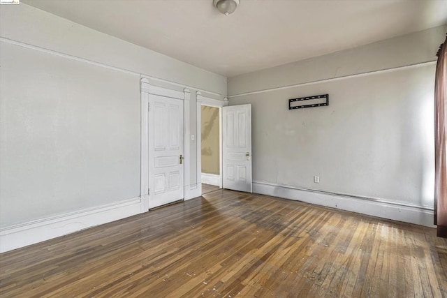 unfurnished bedroom featuring dark hardwood / wood-style floors