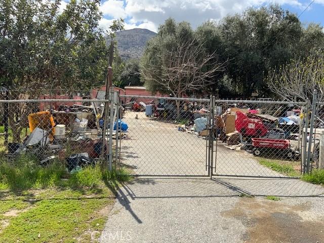 surrounding community featuring a gate, fence, and a mountain view