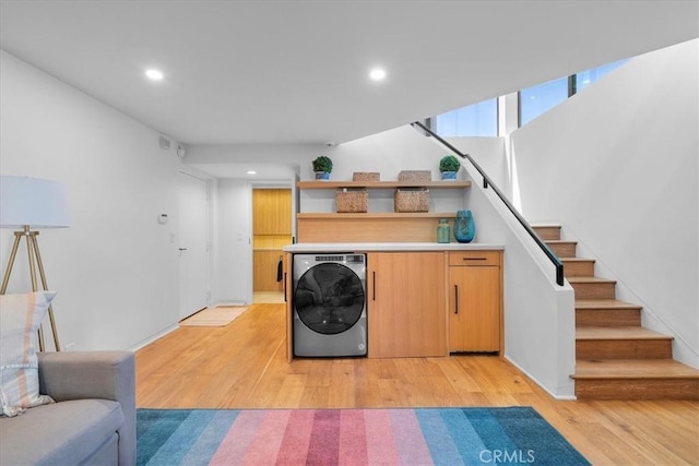 laundry area with washer / clothes dryer and light wood-type flooring