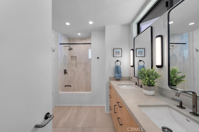 bathroom featuring walk in shower, tile patterned floors, and vanity