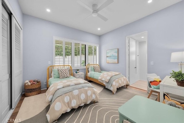 bedroom with hardwood / wood-style flooring, ceiling fan, and a closet