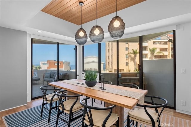 dining space with wood-type flooring and wood ceiling