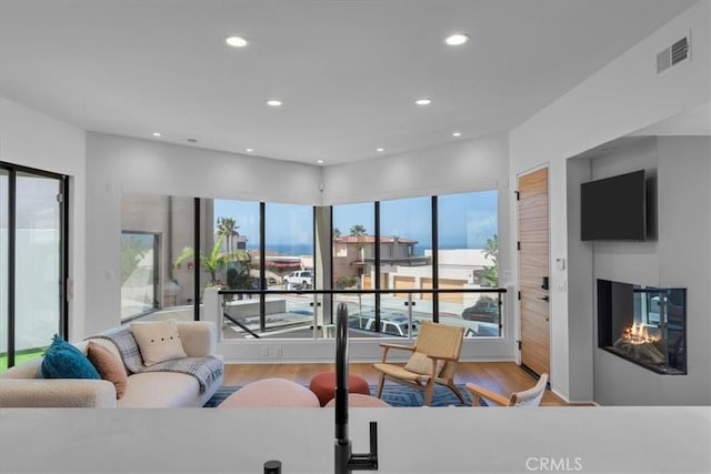 734 Esplanade Unit A, Redondo Beach, CA 90277 - living room with wood finished floors, a multi sided fireplace, and recessed lighting