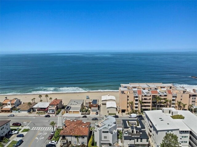 bird's eye view featuring a water view and a beach view