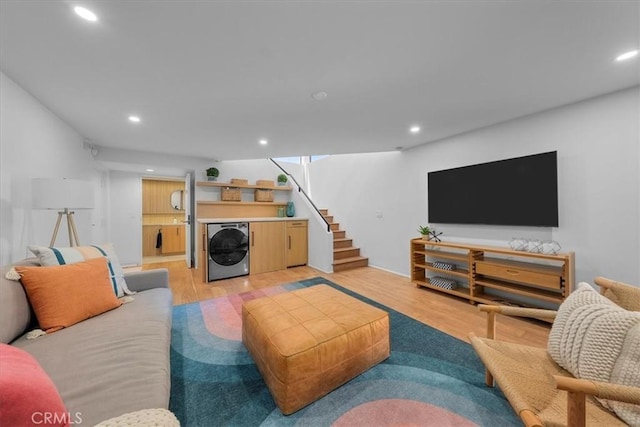 living room featuring washer / dryer and light wood-type flooring