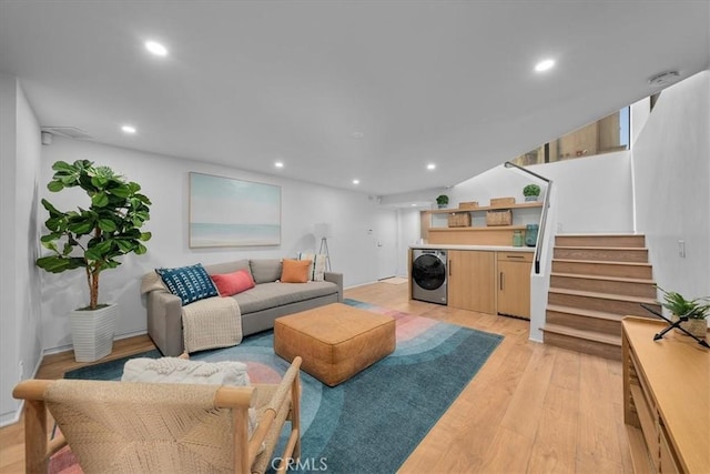 living room featuring washer / clothes dryer and light hardwood / wood-style flooring