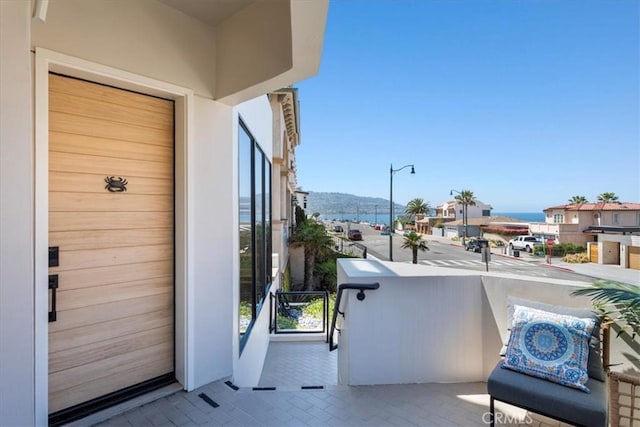 balcony with a water and mountain view