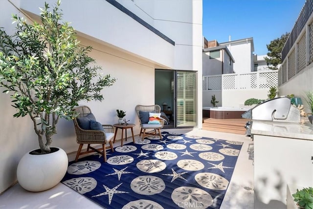 view of patio / terrace featuring a hot tub