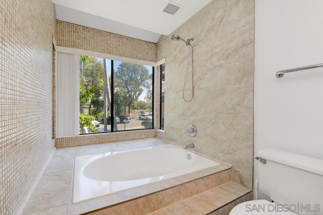 bathroom featuring separate shower and tub and toilet