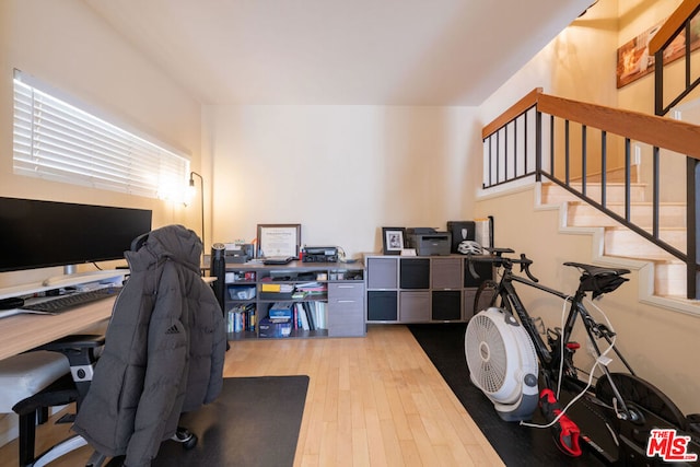 home office with light hardwood / wood-style flooring