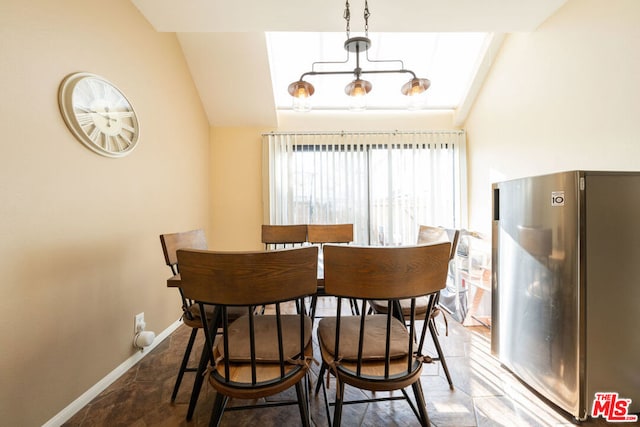 dining room with a notable chandelier and vaulted ceiling