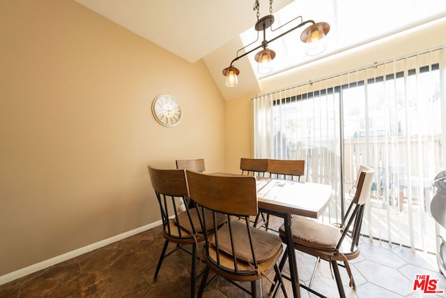 dining area featuring lofted ceiling