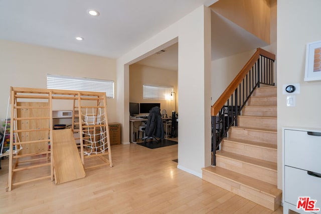 stairway featuring wood-type flooring