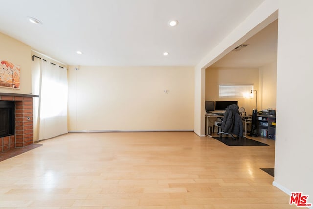 living room featuring a fireplace and light hardwood / wood-style floors