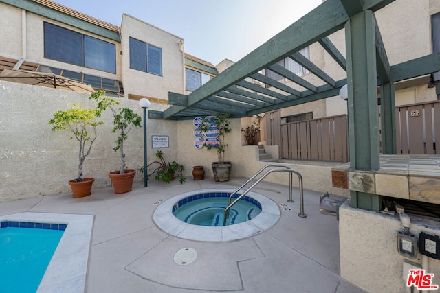 view of swimming pool with a community hot tub and a pergola