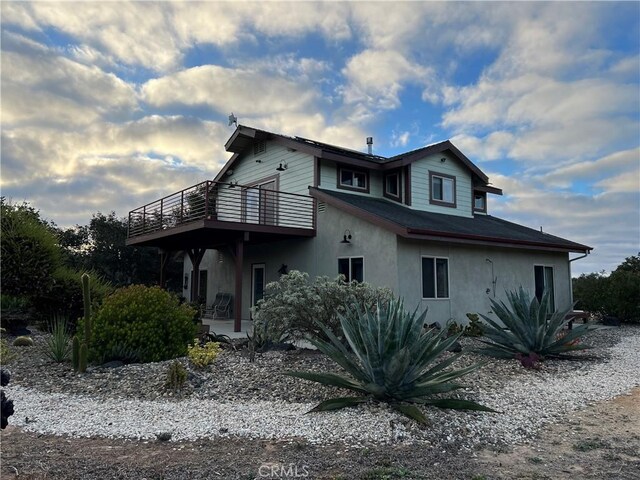 view of property exterior featuring a wooden deck