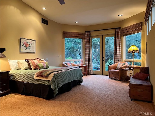 carpeted bedroom with french doors, access to outside, and ceiling fan