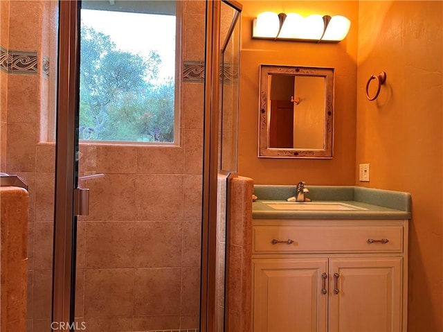 bathroom featuring vanity and a shower with door