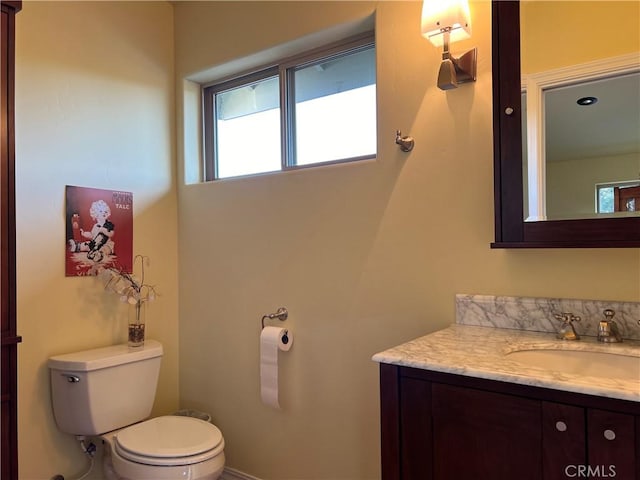 bathroom featuring vanity and toilet