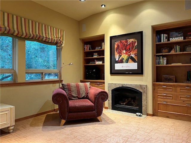 sitting room featuring a fireplace and lofted ceiling