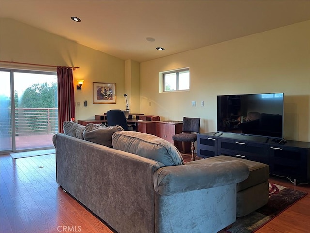 living room with lofted ceiling, wood-type flooring, and a wealth of natural light