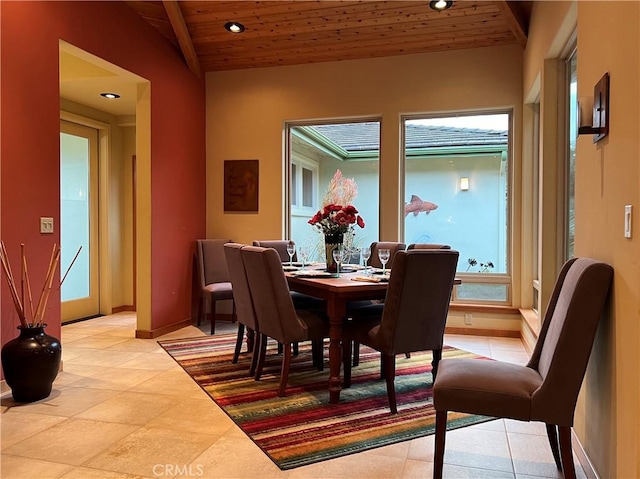 dining space featuring light tile patterned floors, vaulted ceiling, and wood ceiling