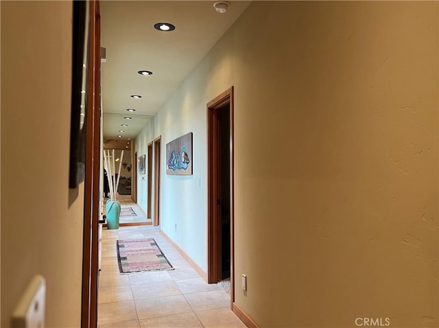 corridor with radiator and light tile patterned flooring