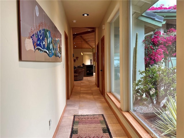 corridor with plenty of natural light and light tile patterned flooring